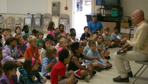 Evo Bluestein leads singing using a dulcimer and many other instruments during the American folk music assembly.