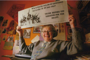 Ellie Bluestein holds the bus placard against the War in Vietnam.
